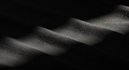Dark textured fabric folds with shadows