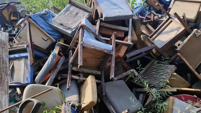 Dumped Broken chairs are abandoned in outdoor in indian government offices. Damaged old wooden chairs dump,  A symbol of lack of teamwork.
