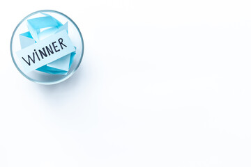 Winner on piece of paper in glass jar, top view. Luck and success concept.