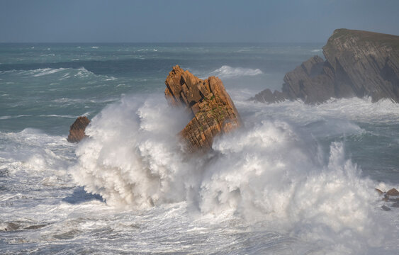 Spain, Liencres. Ocean waves and sea stack formations.