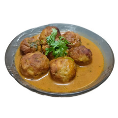Close-up of juicy chicken kofta balls served in a flavorful Indian curry gravy, garnished with fresh coriander, presented in a traditional bowl on white background.