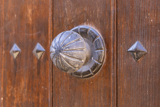 Albaicin, Province of Granada, Andalusia, Spain. Metal knob on an old wooden door.
