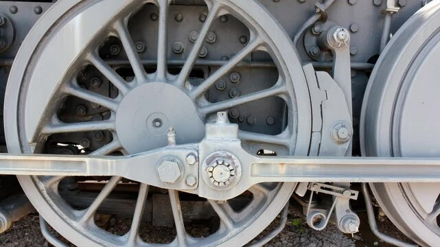 Close-up of the wheels of an old steam train locomotive from the 1940s