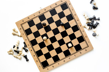 White and black chess pieces on chessboard during the game, top view