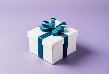 Fototapeta premium A white gift box with a blue ribbon and bow.