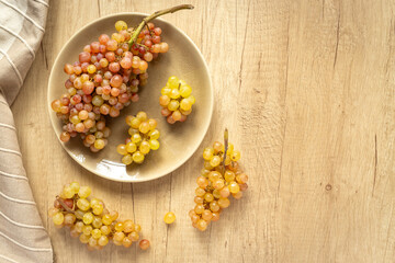 Many fresh green grape clusters isolated, top view