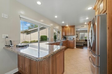 Modern kitchen with granite countertops and natural light.