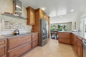 Modern kitchen with wooden cabinets and stainless steel appliances.