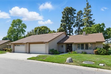 Suburban house with driveway and lawn.