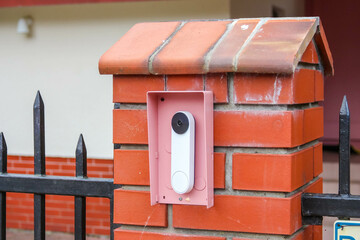 Modern Brick Mailbox with White Vertical Slot and Decorative Iron Fence Integration