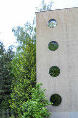 Modern Architectural Column with Circular Glass Elements Providing Natural Light to Building...