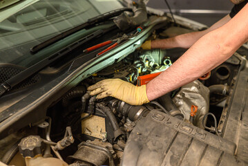 technician hands repairing vehicle engine professional inspecting car engine for repairs