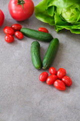 Lettuce, tomato, cucumber and salad on grey background. Fresh vegetables	