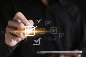 Obraz premium Checklist concept, Checklist with checkmarks and online quality assessment. Businessman checking mark on checkboxes.