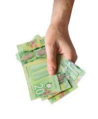 Person's hand holding twenty dollar canadian cash money bills isolated cutout on transparent