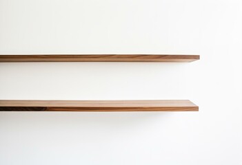 A pair of wooden shelves on a white wall.