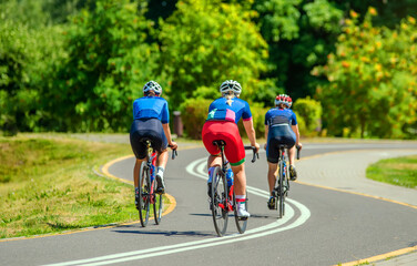 Cyclists ride on the bike path in the city Park
