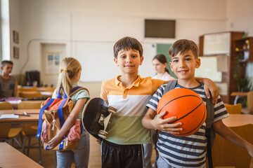 Portrait of school boys classmates stand embracing in the classroom © Miljan Živković