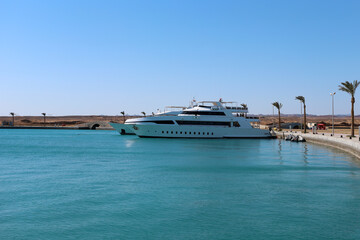 Luxury White Yacht Moored at Port Ghalib Marina, Egypt – Calm Turquoise Waters and Desert...
