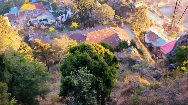 Mussoorie forest Uttarakhand winter lineis visible on the western horizon in the evening from midOctober to January. Sun sets, shades of yellow, red, orange, purple.