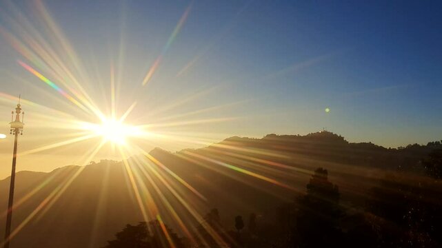 Mussoorie forest Uttarakhand winter lineis visible on the western horizon in the evening from midOctober to January. Sun sets, shades of yellow, red, orange, purple.