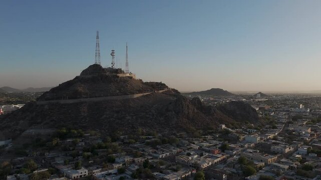 Campana hill dominating hermosillo skyline during golden hour