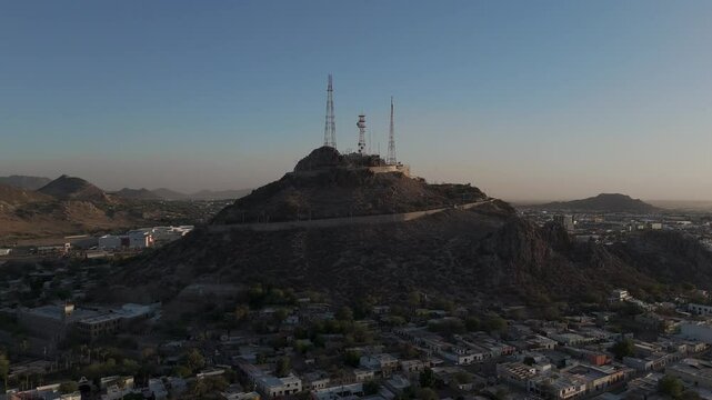 Campana hill dominating hermosillo skyline at sunset