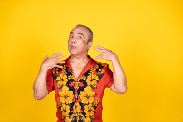 Tourist gesturing against yellow background in studio shot