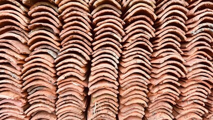 ordered background of orange clay tiles stacked on top of one another