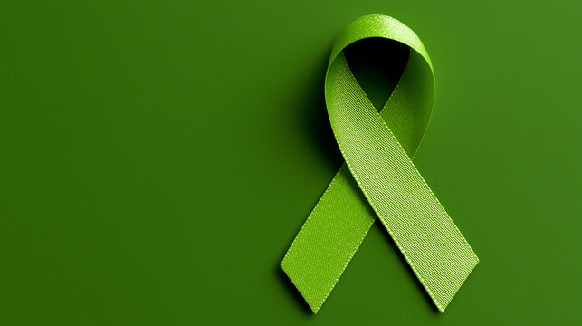 World bipolar day. Green ribbon on green background. Mental health awareness day, Depression, Cerebral palsy. World kidney day. top view. Copy space - Powered by Adobe