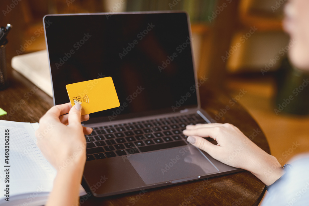 Poster online shopping concept. over the shoulder view of unrecognizable woman holding credit card in hand 