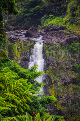 The fresh flowing river of water dives over the rocky shelf to the water below.