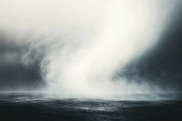 Obraz premium A swirling vortex of mist over a dark, still ocean, creating a dramatic, ethereal scene.