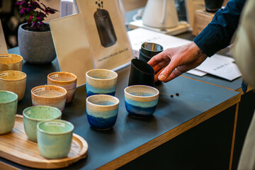A lively scene from a coffee festival in Copenhagen, featuring baristas at work, diverse coffee cups, engaged customers, brewing techniques, and the rich culture surrounding coffee.