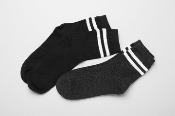 Pairs of socks on light background, top view