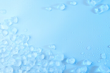 Cubes of clear ice on light blue background, flat lay. Space for text
