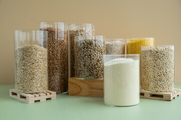 Refillable glass jar with raw grain porridge. Copy space Refill product format eco-friendly living....