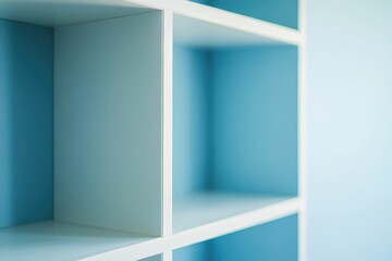Fototapeta premium Empty white shelves against a light blue wall, minimalist and clean design.