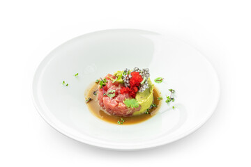 Tartar with tuna, avocado and red caviar decorated with microgreens on plate isolated on white background. Fish and seafood, close up, top view