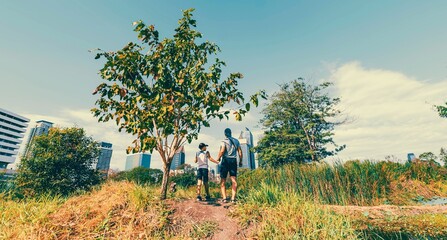 Father and son visit in the city park called Benjakitti in Bangkok 