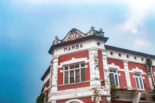 The historic Marba building in Semarang Old Town, showcasing colonial architecture with its red brick and white trim, stands as a testament to the city's rich heritage, Indonesia, 16 November 2024