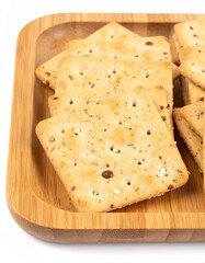 Gluten-free crackers on wooden tray isolated on white background with full depth of field for snack or healthy eating concept