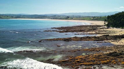 Stunning and Beautiful Coastal Landscape Featuring a Rocky Shoreline and Sparkling Clear Water