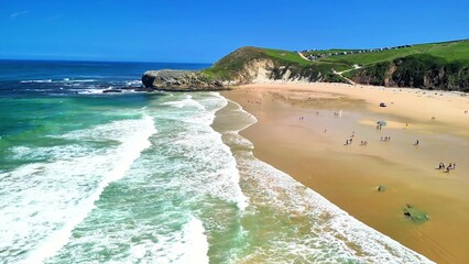It is truly a Beautiful Day at the Beach where Waves crash gently against the Sand