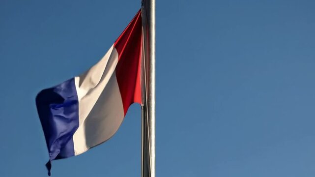 Francia flag with the colors blue, white, and red is flying in the sky