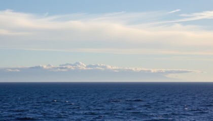 Fototapeta premium Calm ocean waves reflecting clouds coastal horizon nature photography tranquil seascape wide-angle view serenity
