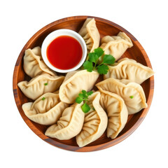 Delicious momos in wooden bowl with sauce isolated on transparent background