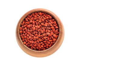 Organic red annatto seeds in the bowl - Bixa Orellana.