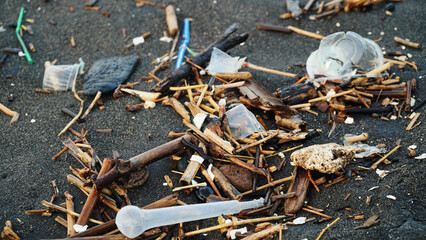 Garbage is scattered on the beach sand