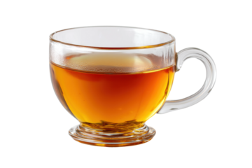 Clear glass cup filled with amber tea against black background, cut out